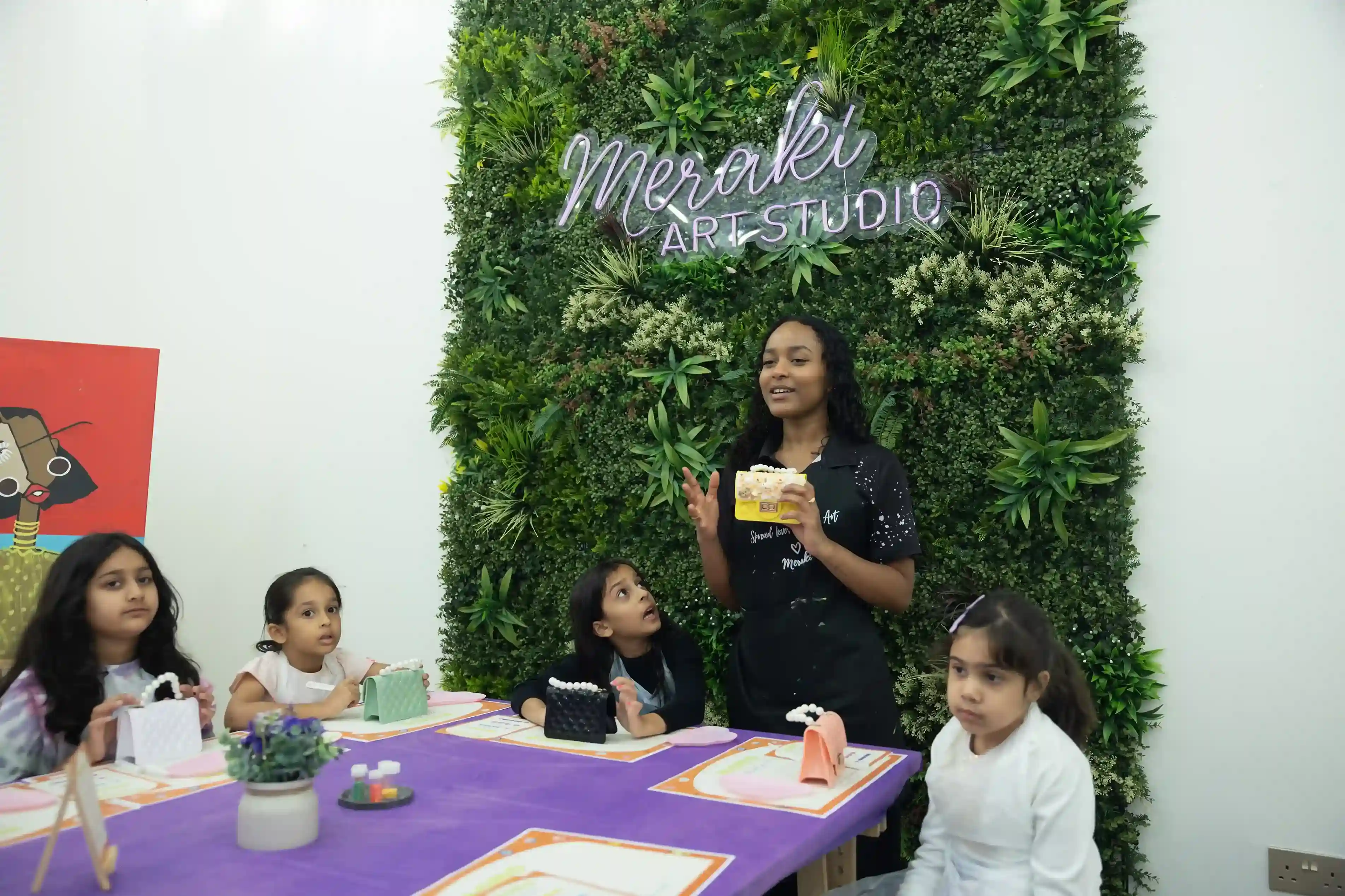 Inside the studio, a Meraki instructor engages participants in a hands-on session